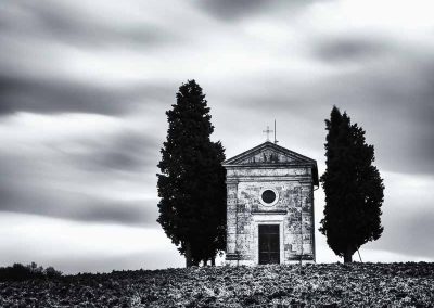A small chapel with cypresses photo